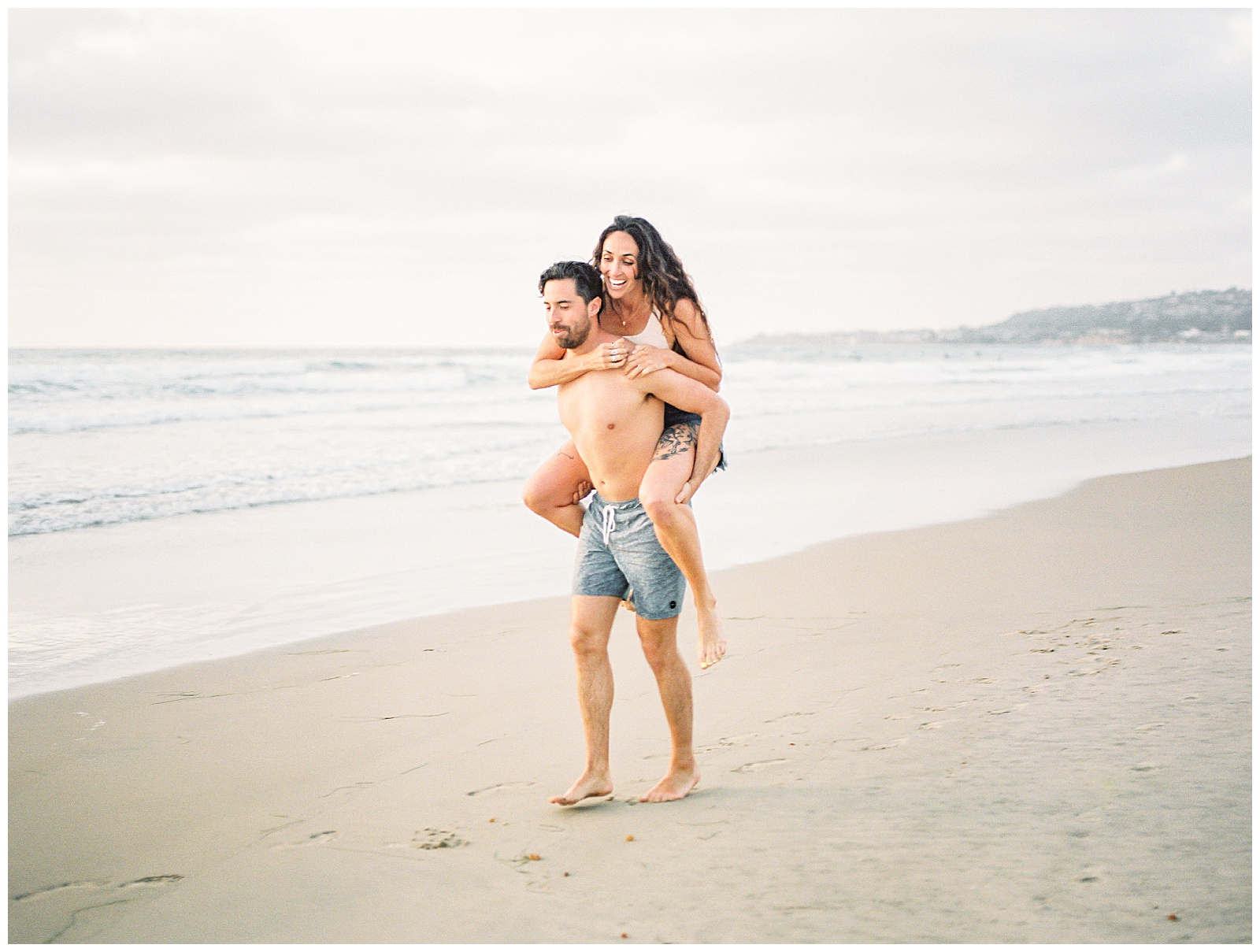 fun playful engagement session on the beach