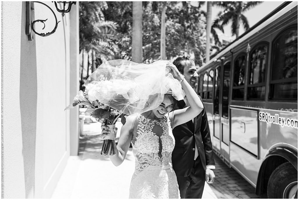 Bride and groom by wedding trolly that takes them to wedding ceremony site. Black and white image.