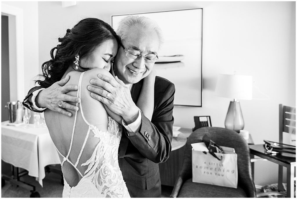 Bride hugs her father. Black and white image | By Sarasota Wedding Photographer, Nikki Golden