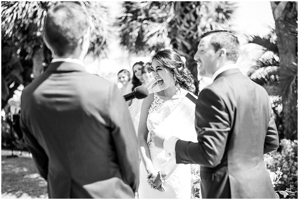 Black and white image of bride and groom exchanging vows