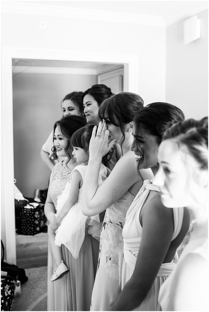 Bridesmaids reactions to seeing bride. Black and white image.