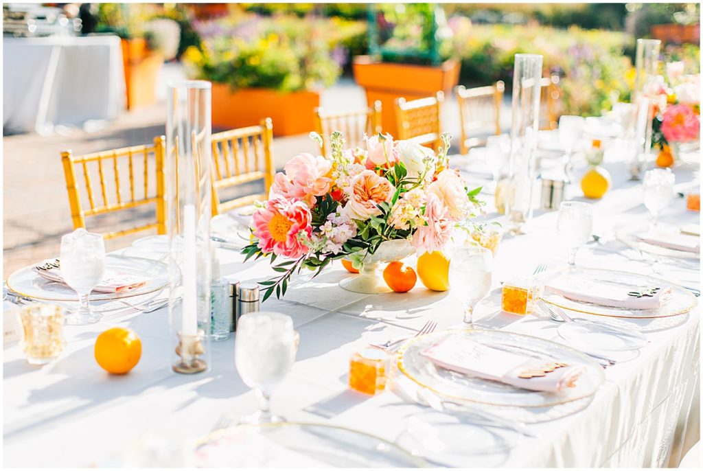 Wedding table decorated with bright oranges and pink flowers  | By Sarasota Wedding Photographer, Nikki Golden
