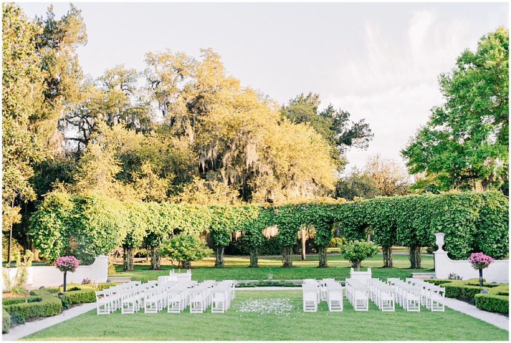 Wedding ceremony set-up with white chairs and flower petals at Jekyll Island Resort Club