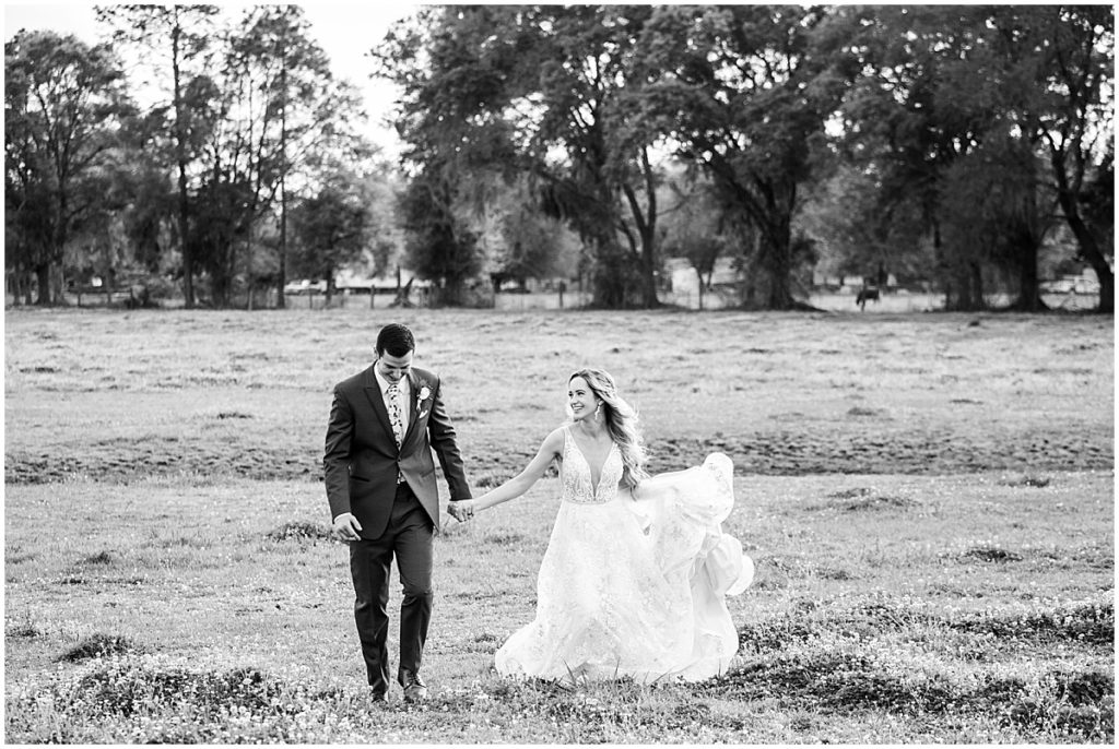 Black and white portrait of Bride and groom in field at Tuscan Rose Vineyards