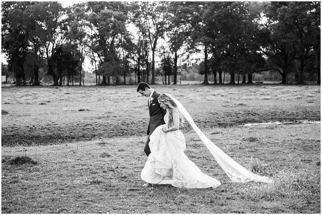 Black and white portrait of Bride and groom in field at Tuscan Rose Vineyards