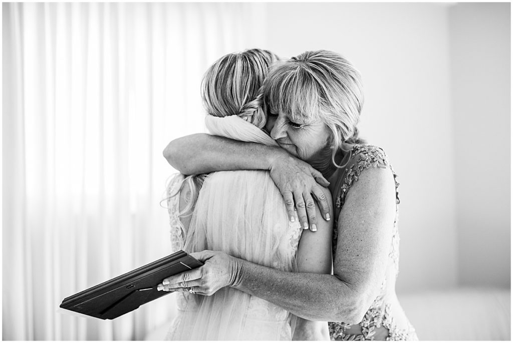 Bride hugging mother before wedding
