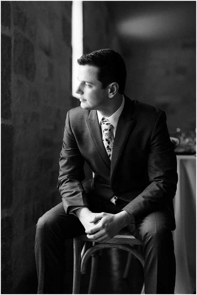 Black and white portrait of the groom sitting