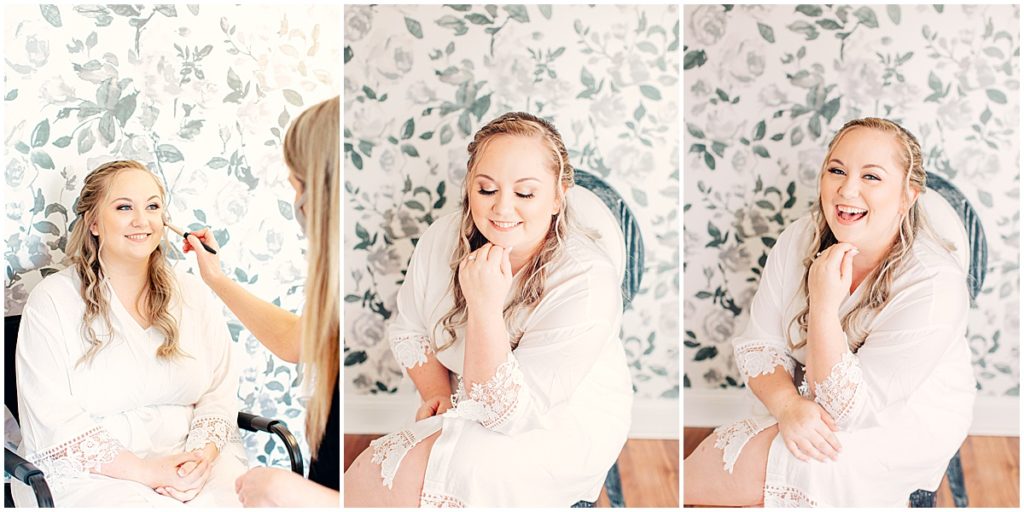 Bride having makeup done in front of floral wall