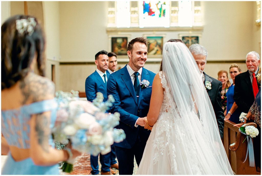 Groom meeting his bride walking down the aisle at the The Basillica in St Augustine | By St Augustine Photographer, Nikki Golden