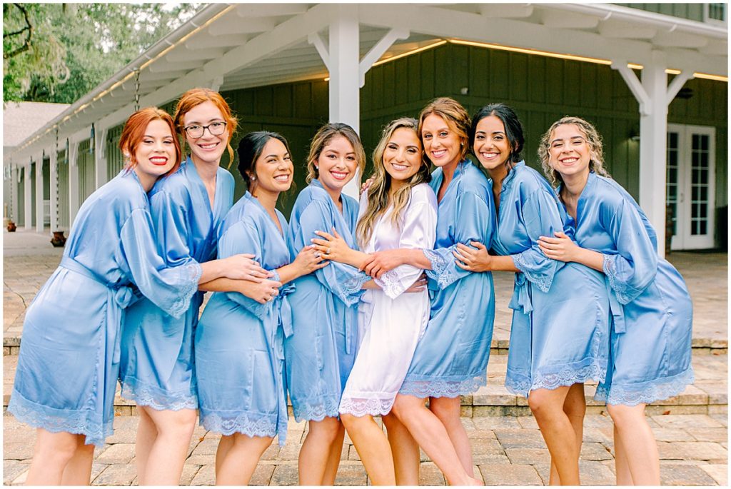 Bride with bridesmaids in blue robes