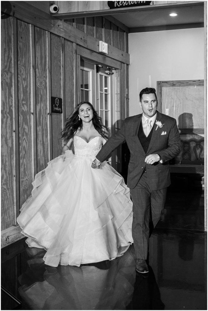 Black and white shot of bride and groom at wedding reception