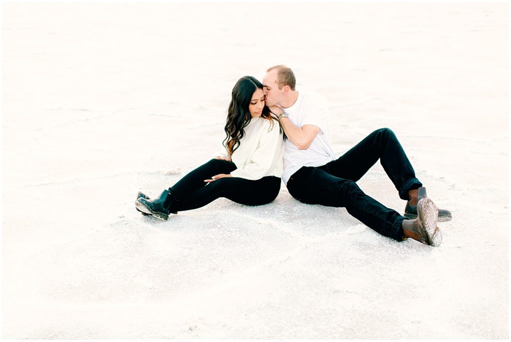 Couple sitting down at the Bonneville Utah Salt Flats | Film Wedding Photographer | Nikki Golden