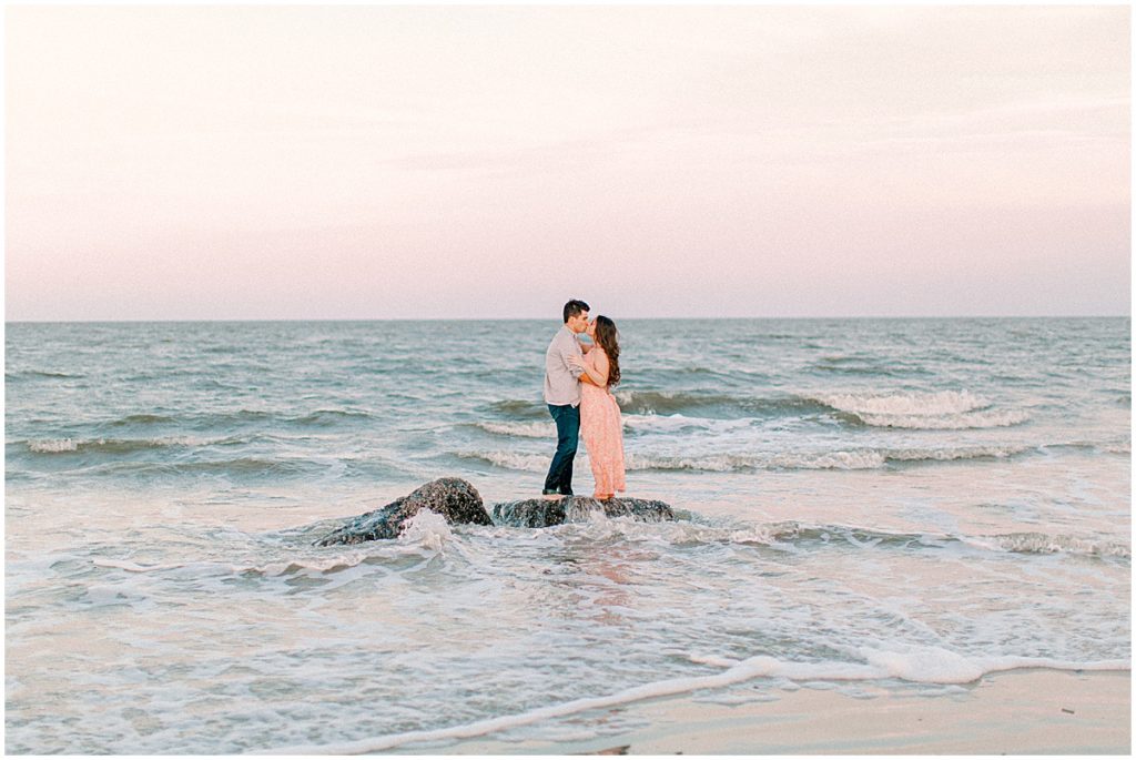 Couple embracing at sunset on the beach by Jekyll Island wedding photographer.