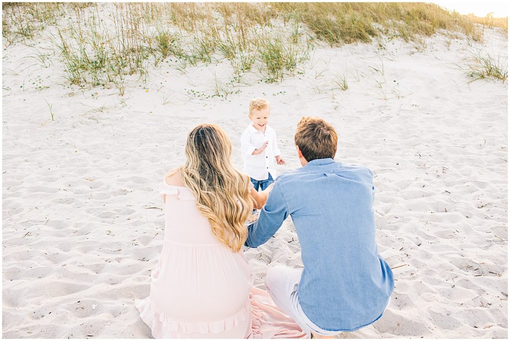 Family with toddler son on beach by Florida family photographer, Nikki Golden