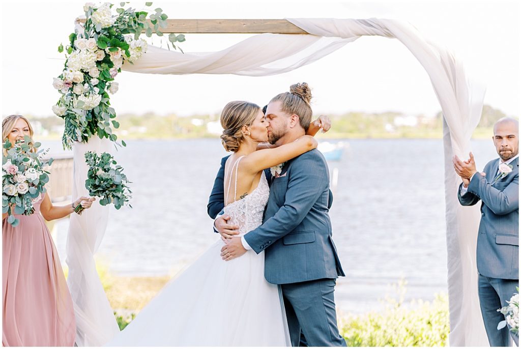 Bride and grooms first kiss under wedding arch | St Augustine wedding 
