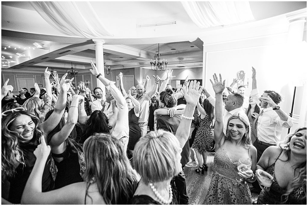 Black and white image of guests dancing at wedding reception party at River House Events, St Augustine