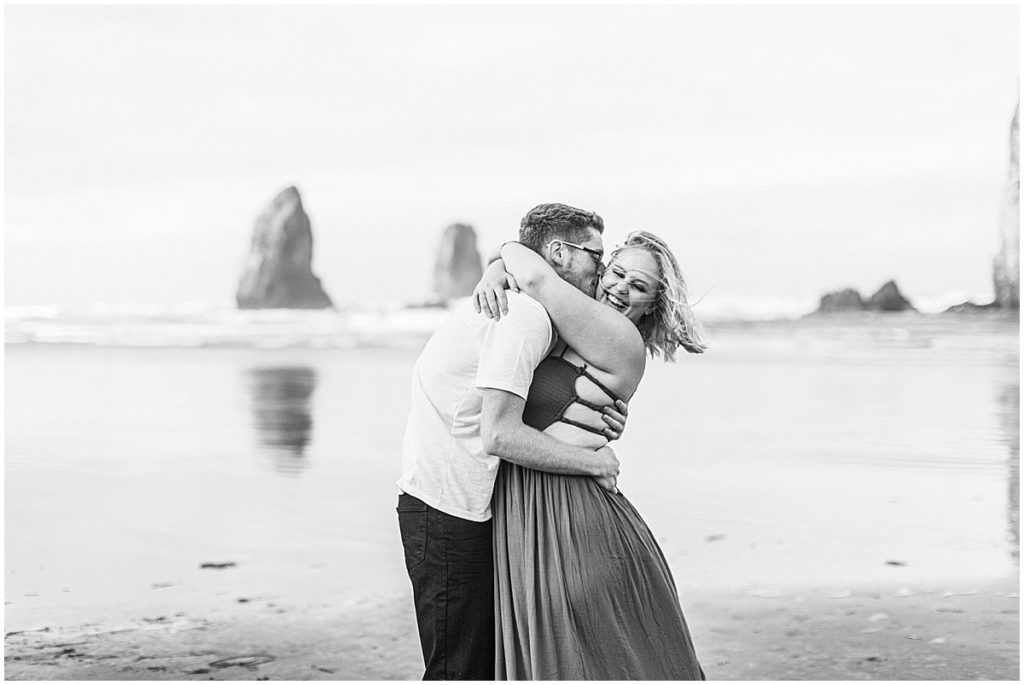 Black and white image of couple at Cannon Beach, Oregon | Nikki Golden Photography | Luxury Wedding Photographer