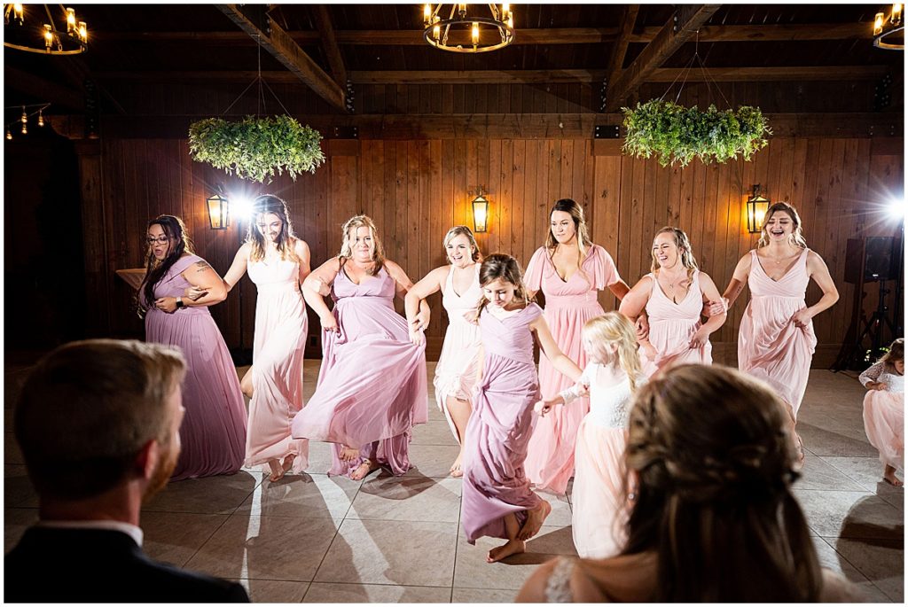 Bridesmaids performing a dance for the bride and groom at wedding reception | Nikki Golden Photography 