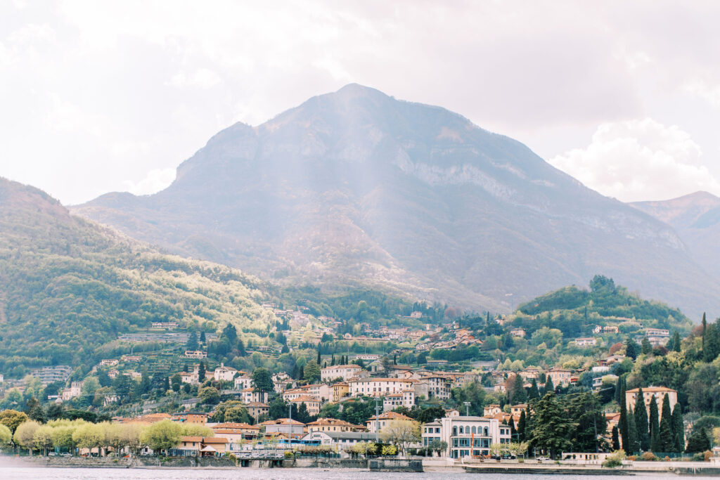 Landscape photo of buildings taken from a boat for a lake como wedding in Italy
