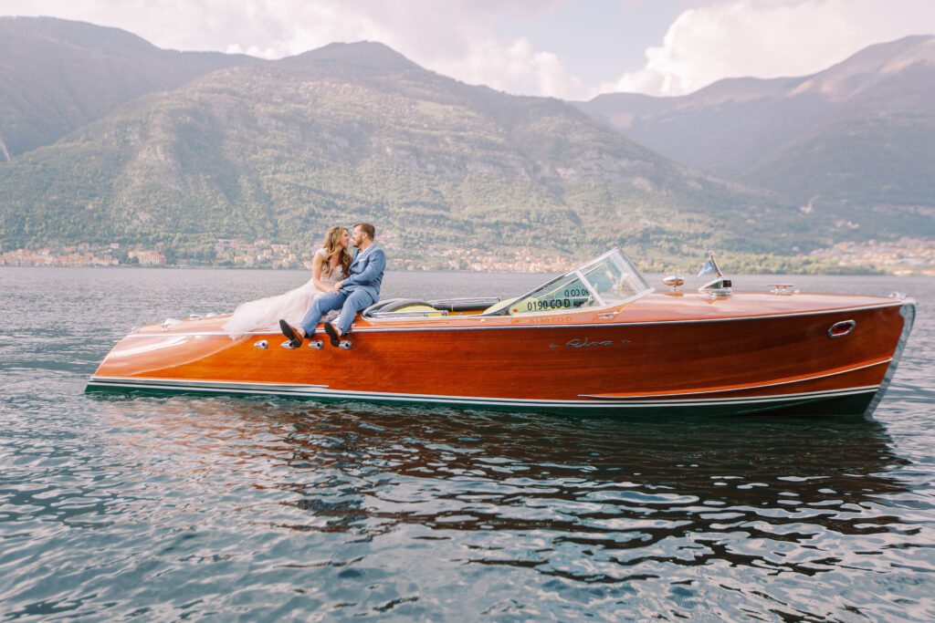 Bride and groom sitting on a boat in lake como italy