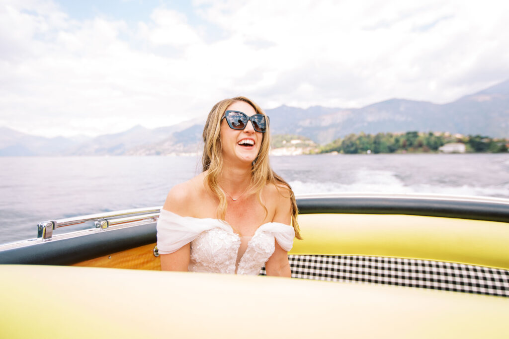 bride laughing on a boat in lake como italy