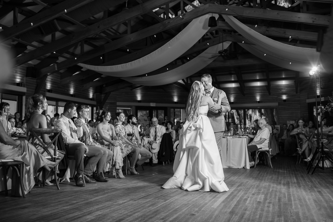 Black and white image of a bride and groom at their first dance 