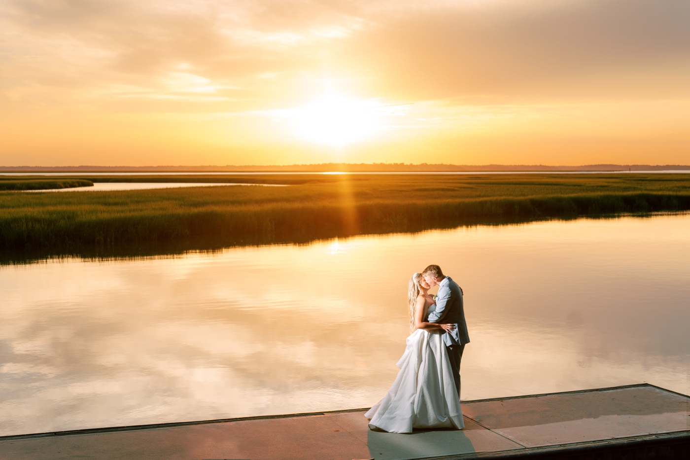 Sunset bride and groom picture over the marsh and sun on Amelia Island 