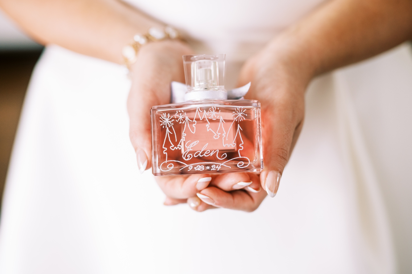 perfume bottle etched with a silhouette of Cinderella's castle with the name Eden and her wedding date